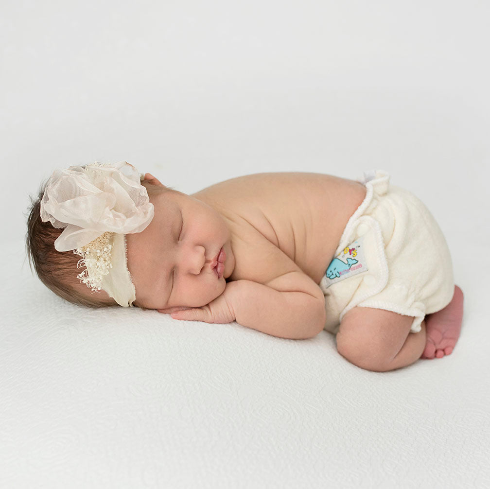 Photo of a sleeping baby showing the Mother-ease Sandy's Fitted Diaper