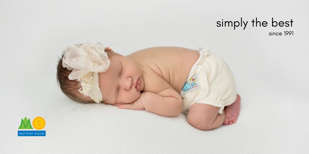 Image of a sleeping baby in a fitted cloth diaper with the phrase simply the best written above